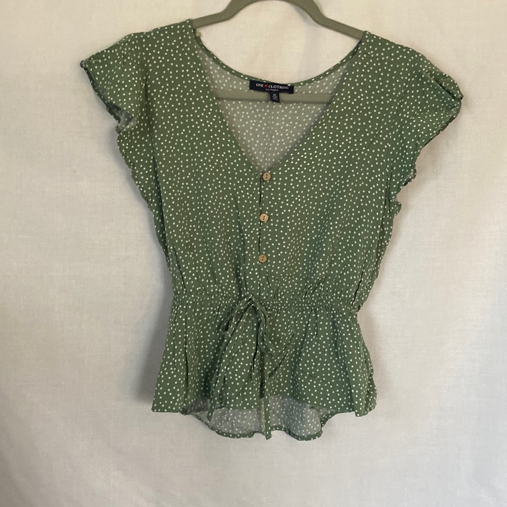 Green and white polka dot shirt